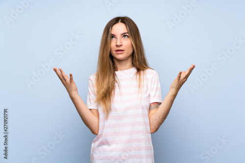 Young woman over isolated blue background frustrated by a bad situation