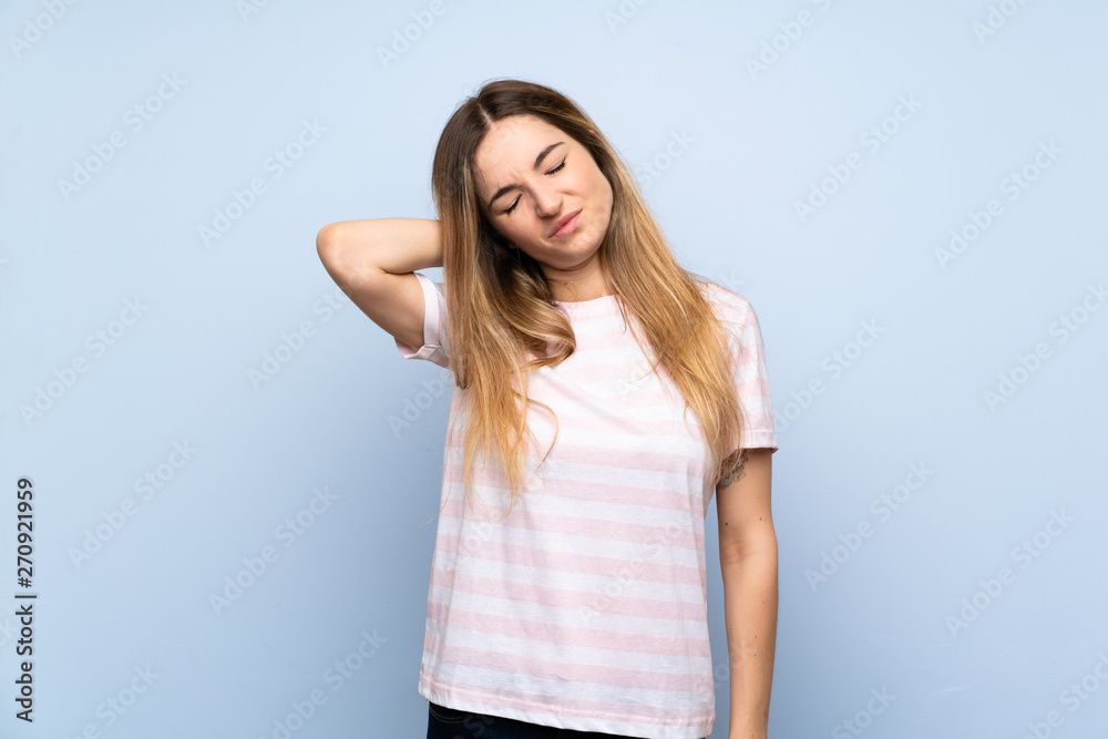 Young woman over isolated blue background with neckache Young woman over isolated blue background with neckache