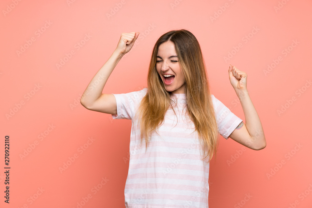 Young woman over isolated pink wall celebrating a victory Young woman over isolated pink wall celebrating a victory