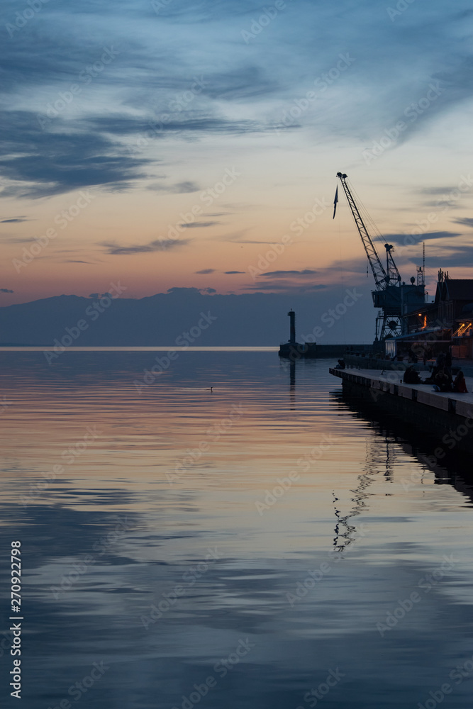 A pier in Thessaloniki, Greece with a an old crane