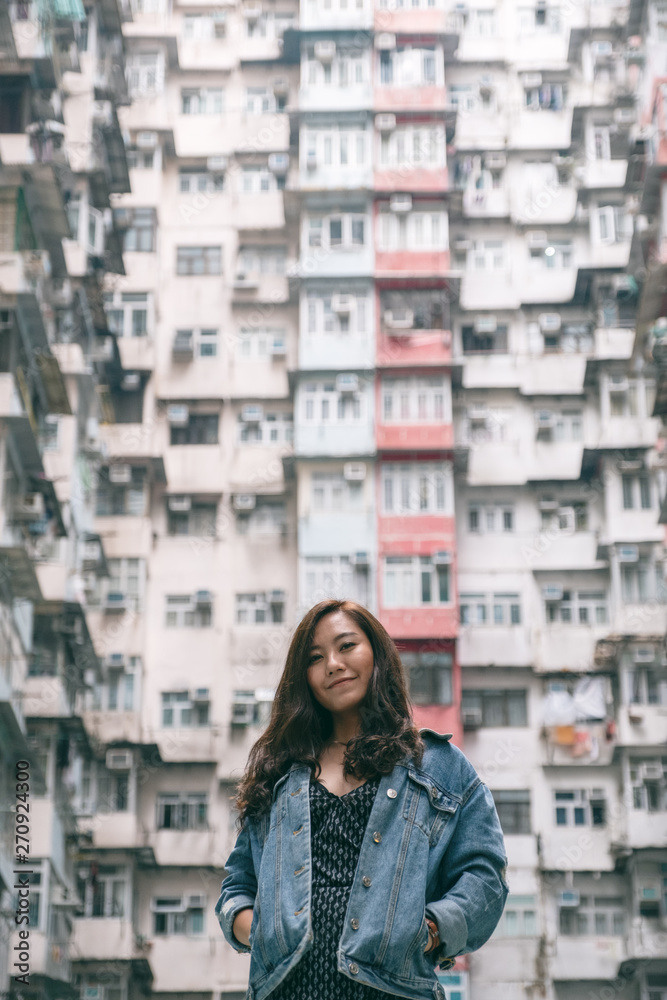 A beautiful asian woman standing among the crowded residential building of the community in Quarry Bay, Hong Kong A beautiful asian woman standing among the crowded residential building of the community in Quarry Bay, Hong Kong