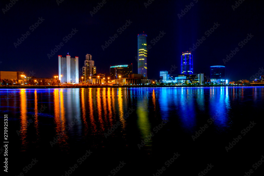Naklejka premium Cityscape of Yekaterinburg, Russia at night with lights reflections on water