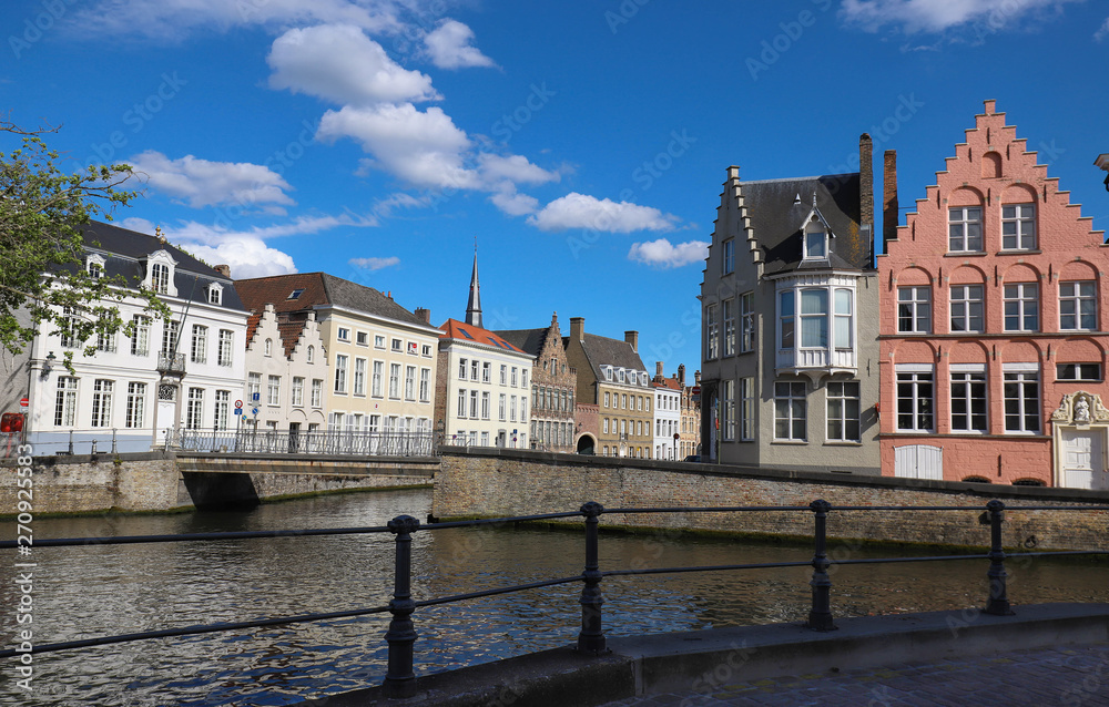 Scenic city view of Bruges canal with beautiful medieval colored houses, bridge and reflections at sunny day. Scenic city view of Bruges canal with beautiful medieval colored houses, bridge and reflections at sunny day.