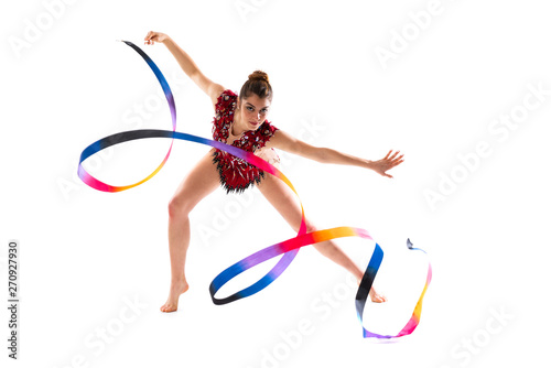 Girl doing rhythmic gymnastics with ribbon . © luismolinero