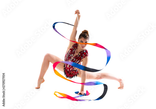 Girl doing rhythmic gymnastics with ribbon .