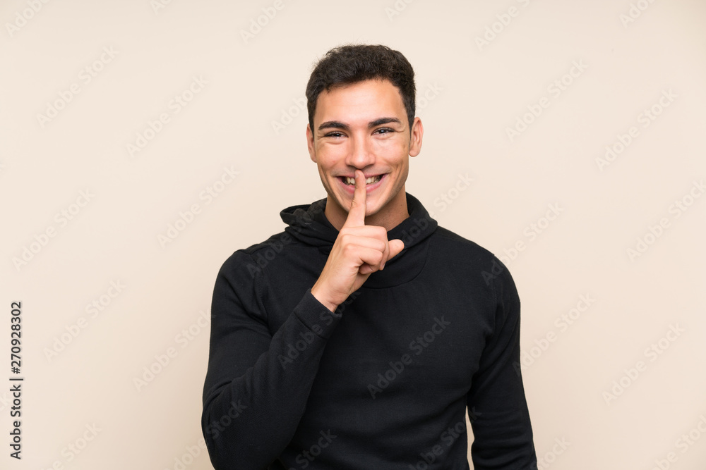 Handsome man over isolated background doing silence gesture Handsome man over isolated background doing silence gesture