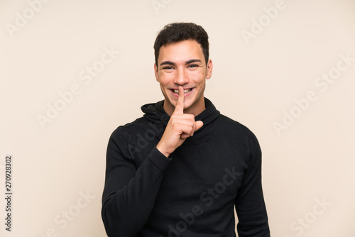 Handsome man over isolated background doing silence gesture