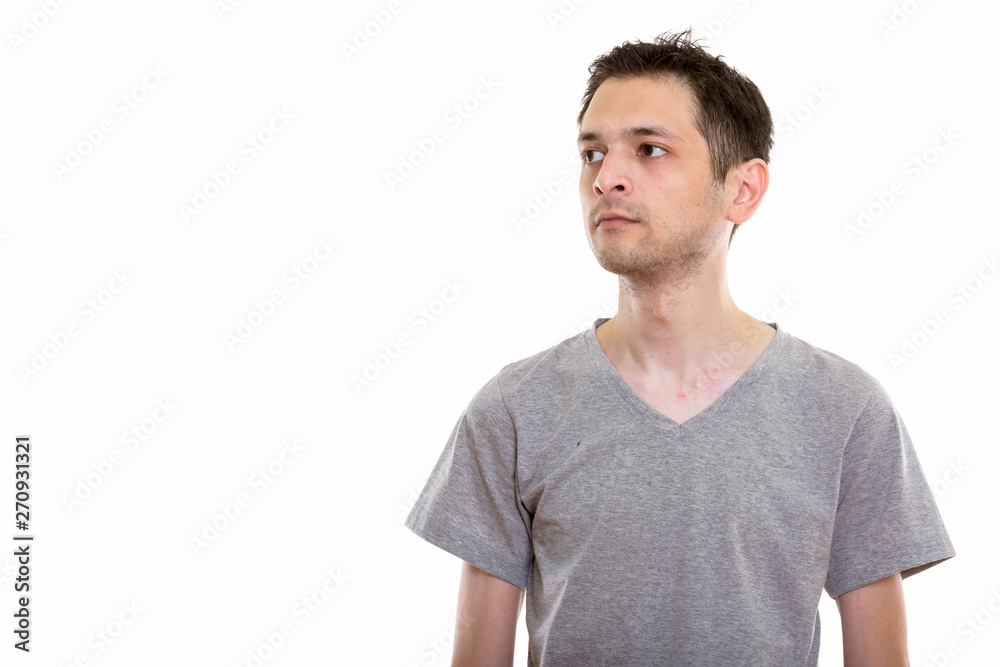 Studio shot of young man thinking while looking at distance Studio shot of young man thinking while looking at distance