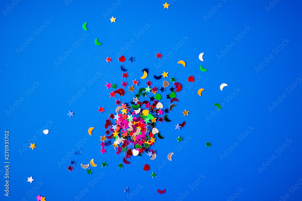 colorful confetti on bright blue background colorful confetti on bright blue background