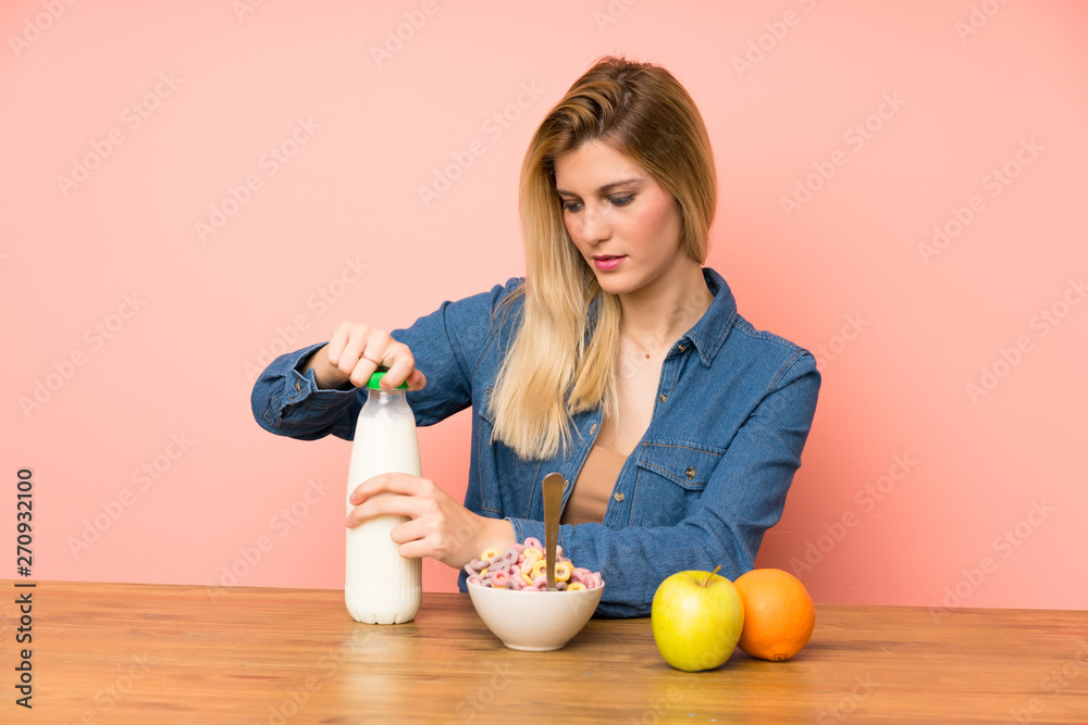 Young blonde woman with bowl of cereals Young blonde woman with bowl of cereals