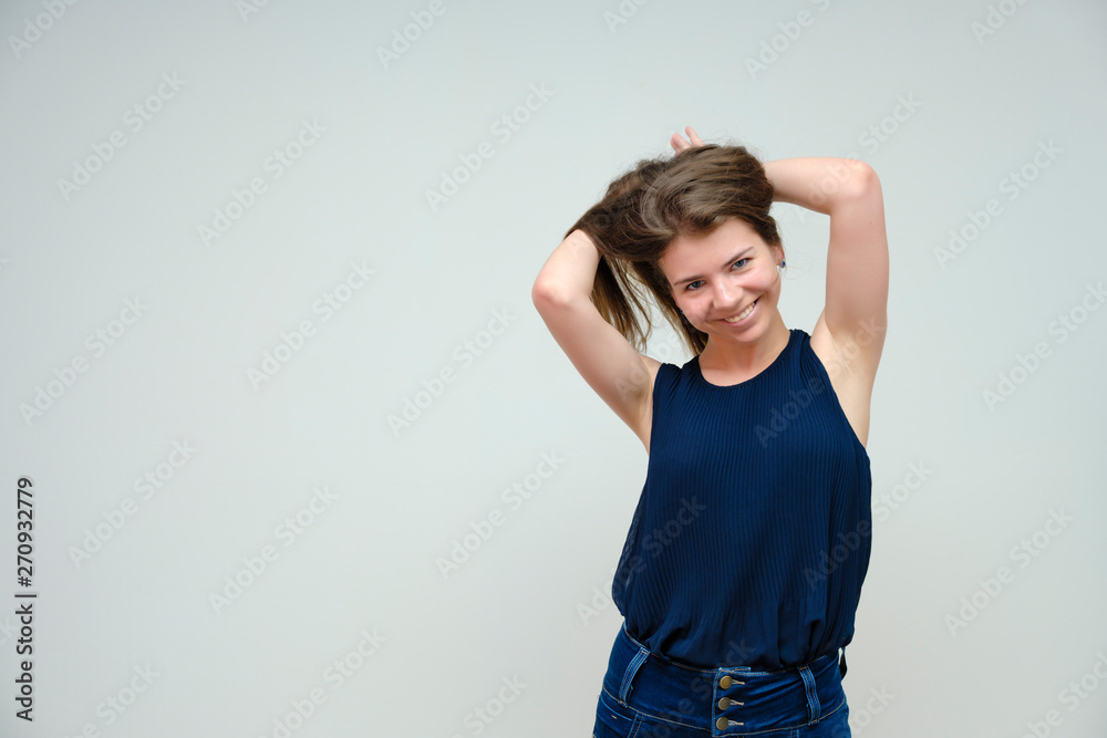 Photo portrait of a beautiful sexy brunette woman girl, smiling and pleased with life, with long flowing dark hair on a white background. Photo portrait of a beautiful sexy brunette woman girl, smiling and pleased with life, with long flowing dark hair on a white background.