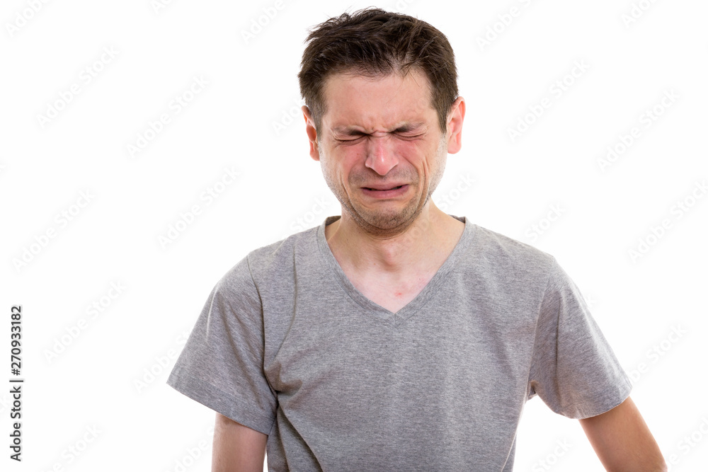 Obraz premium Studio shot of sad young man crying