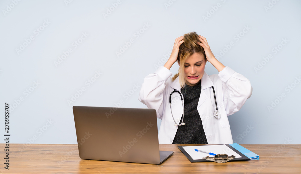Blonde doctor woman frustrated and takes hands on head Blonde doctor woman frustrated and takes hands on head