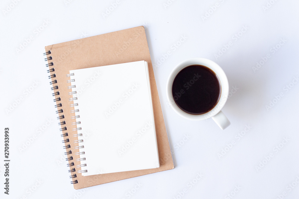 Top view notebook with cup of hot coffee on white background. Top view notebook with cup of hot coffee on white background.