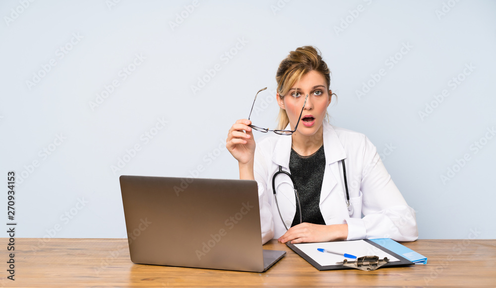 Blonde doctor woman with glasses and surprised Blonde doctor woman with glasses and surprised