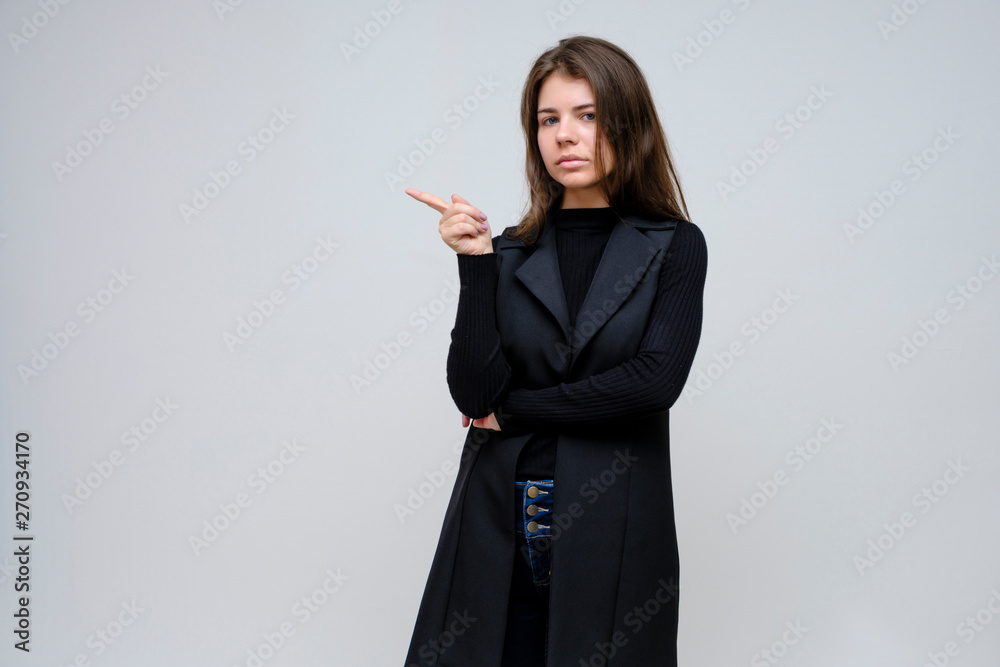 Photo portrait of a beautiful smiling brunette business woman on a white background in a black business suit with long beautiful dark hair in the studio. Photo portrait of a beautiful smiling brunette business woman on a white background in a black business suit with long beautiful dark hair in the studio.