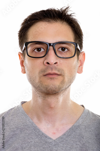 Face of young man wearing eyeglasses and looking at camera © Ranta Images