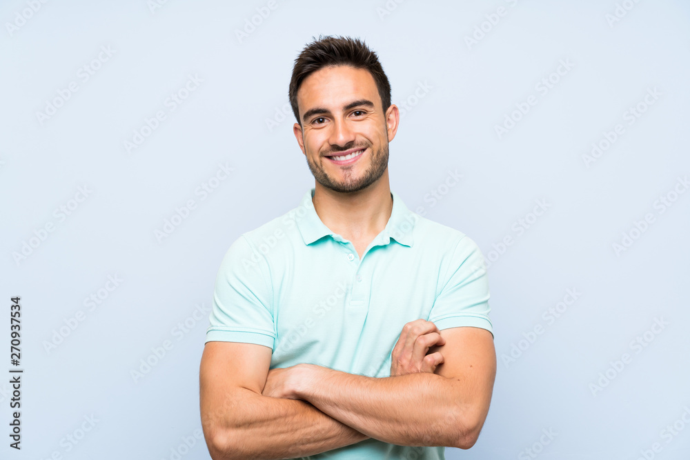 Handsome young man over isolated background keeping the arms crossed in frontal position Handsome young man over isolated background keeping the arms crossed in frontal position