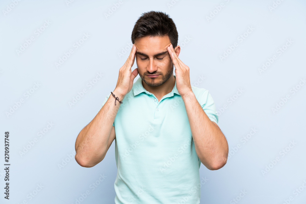 Handsome young man over isolated background with headache Handsome young man over isolated background with headache