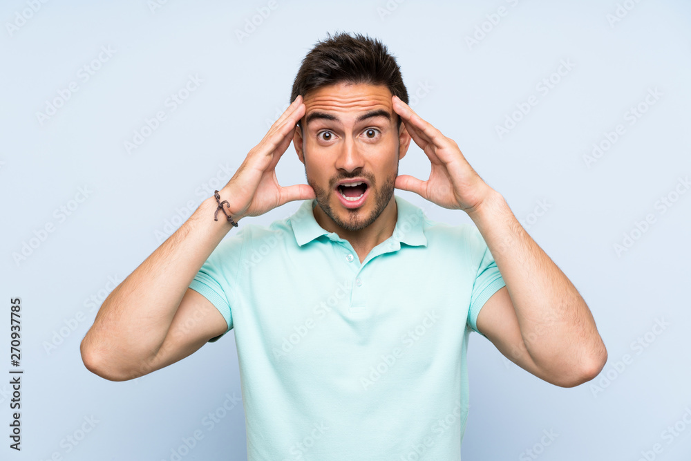 Handsome young man over isolated background with surprise expression Handsome young man over isolated background with surprise expression