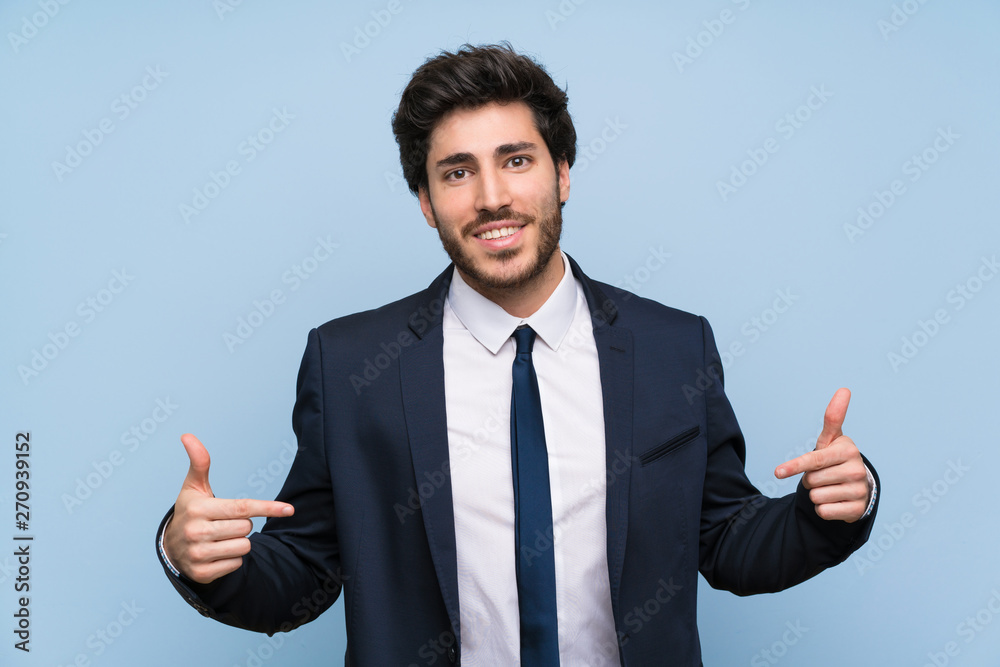 Businessman over isolated blue wall proud and self-satisfied Businessman over isolated blue wall proud and self-satisfied