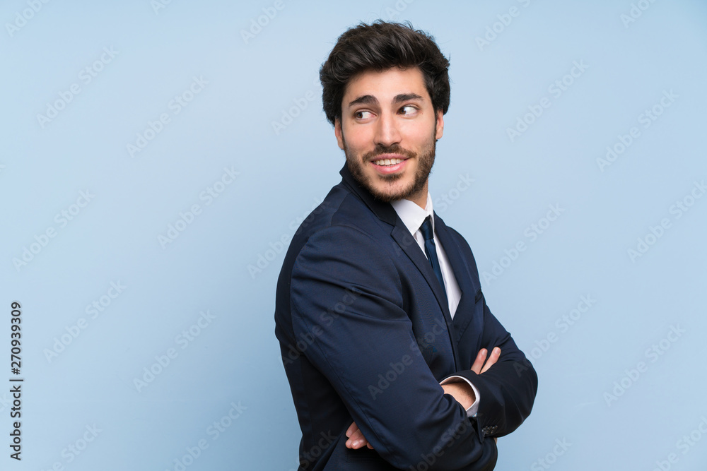 Businessman over isolated blue wall with arms crossed and happy Businessman over isolated blue wall with arms crossed and happy