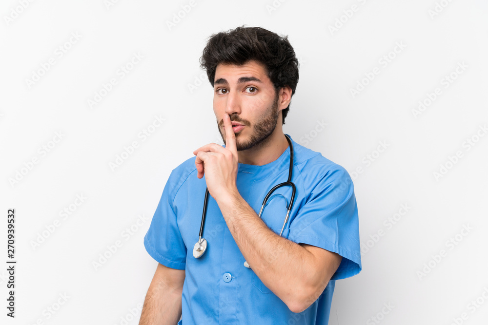 Surgeon doctor man over isolated white wall doing silence gesture Surgeon doctor man over isolated white wall doing silence gesture