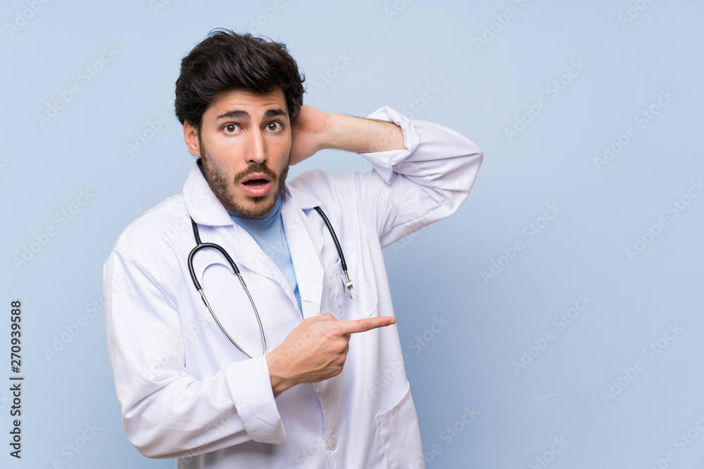Doctor man pointing finger to the side and presenting a product Doctor man pointing finger to the side and presenting a product