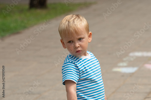Sad boy with striped t-shirt outside © spritnyuk