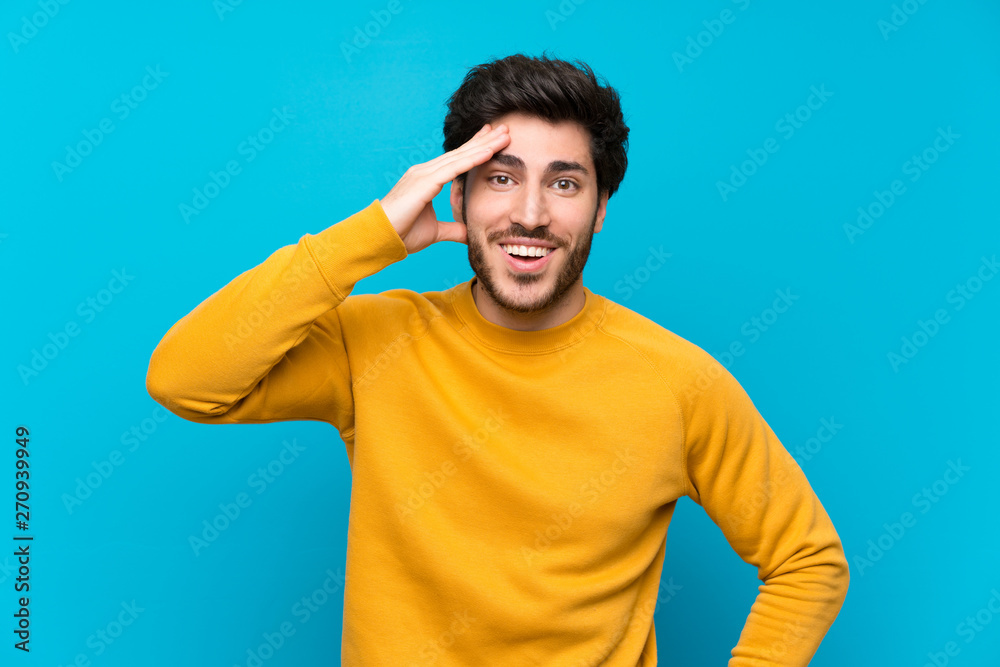 Handsome over isolated blue wall has just realized something and has intending the solution Handsome over isolated blue wall has just realized something and has intending the solution