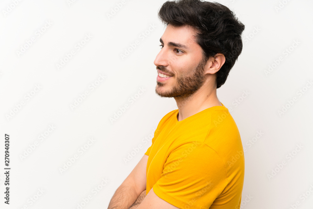Handsome over isolated white wall standing and looking to the side Handsome over isolated white wall standing and looking to the side
