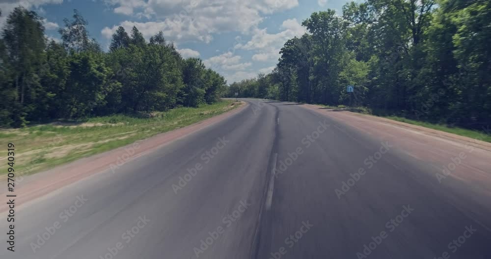 Driving on the road. High angle view while driving car on the empty road , vehicle shot. View from roof car to the countryside road with beautiful summer landscape. Real time Driving on the road. High angle view while driving car on the empty road , vehicle shot. View from roof car to the countryside road with beautiful summer landscape. Real time