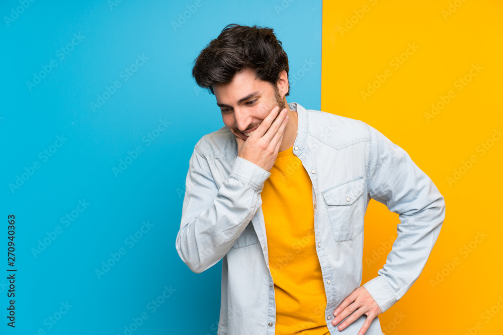 Handsome over isolated colorful background smiling a lot Handsome over isolated colorful background smiling a lot
