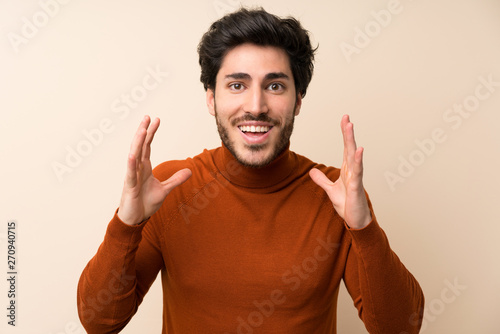 Handsome over isolated wall with surprise and shocked facial expression © luismolinero