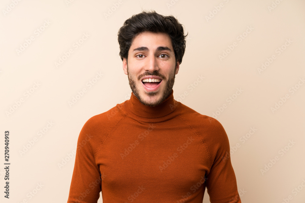 Handsome over isolated wall with surprise facial expression Handsome over isolated wall with surprise facial expression
