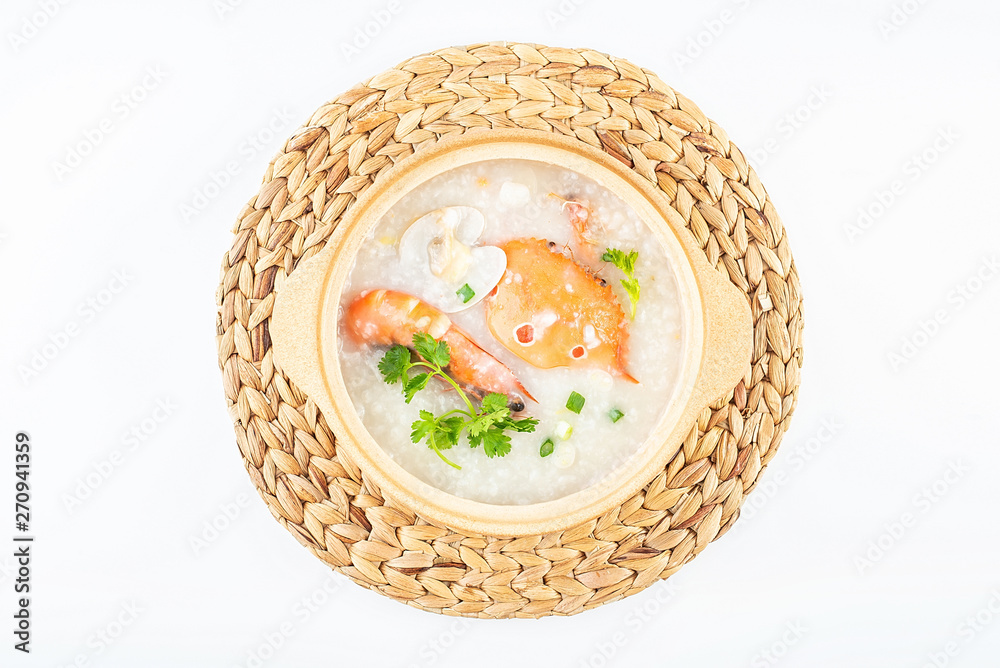 A pot of delicious crab seafood porridge on a white background A pot of delicious crab seafood porridge on a white background