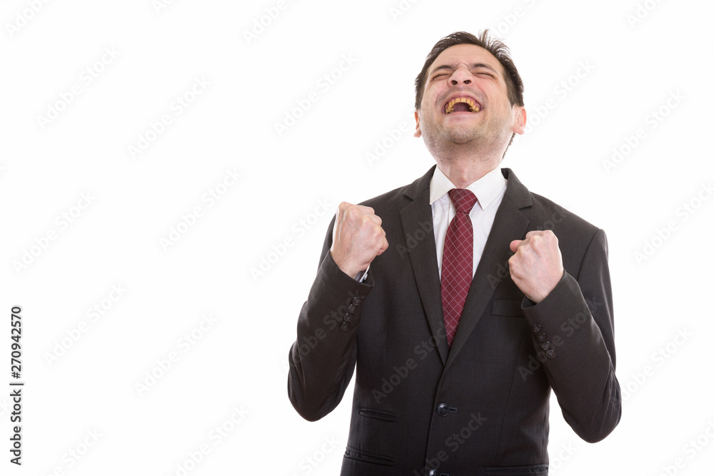 Studio shot of happy young businessman smiling while looking exc Studio shot of happy young businessman smiling while looking exc