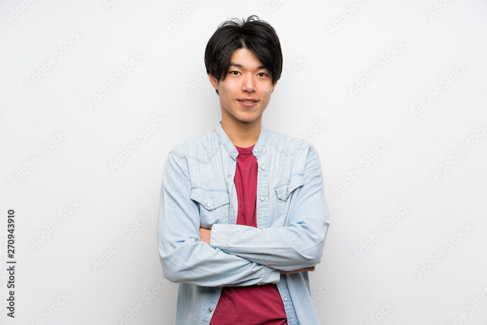 Asian man on isolated white background keeping the arms crossed in frontal position Asian man on isolated white background keeping the arms crossed in frontal position