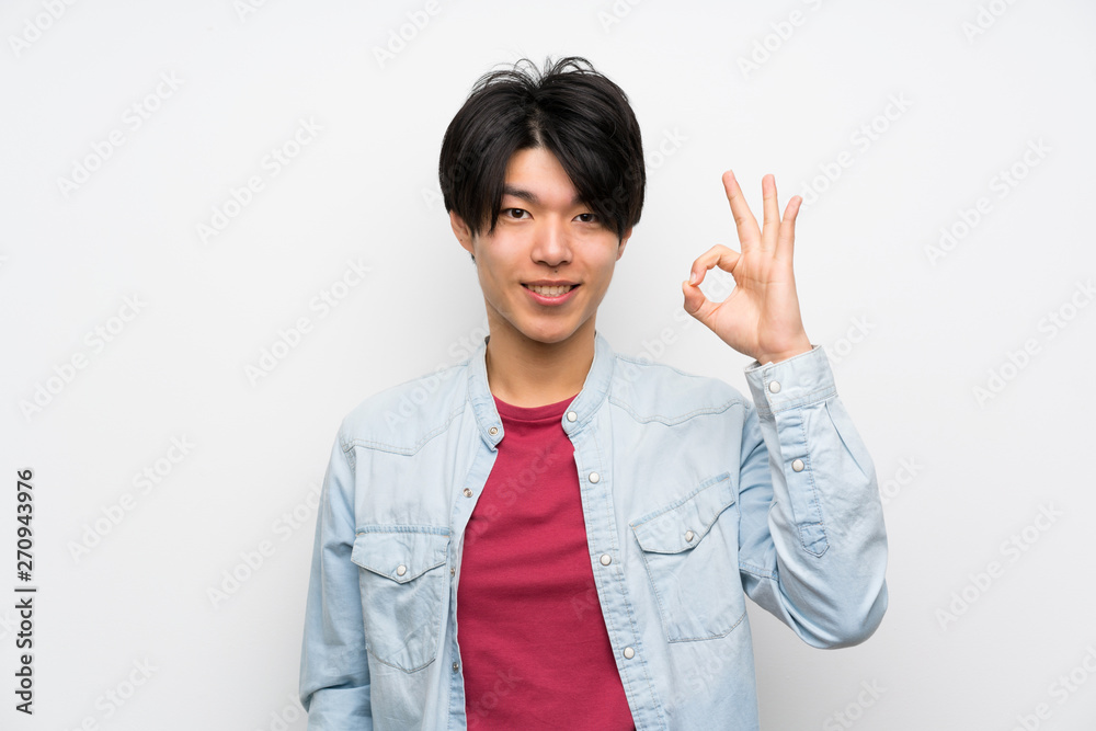 Asian man on isolated white background showing ok sign with fingers Asian man on isolated white background showing ok sign with fingers