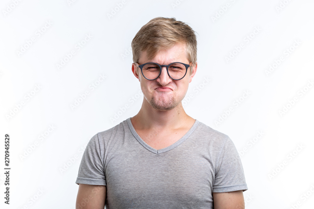 People and emotions concept - Unhappy funny man isolated over white background People and emotions concept - Unhappy funny man isolated over white background