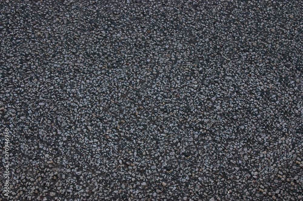 Asphalt roadway with a rough dark surface .Texture or background. Asphalt roadway with a rough dark surface .Texture or background.