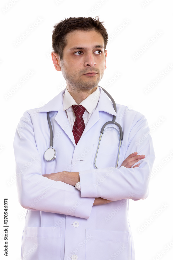 Studio shot of young man doctor thinking with arms crossed Studio shot of young man doctor thinking with arms crossed