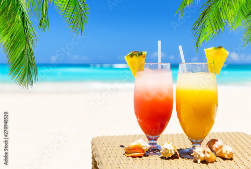 Fototapeta Naklejka Na Ścianę i Meble -  Two tropical fresh juices on white sandy beach