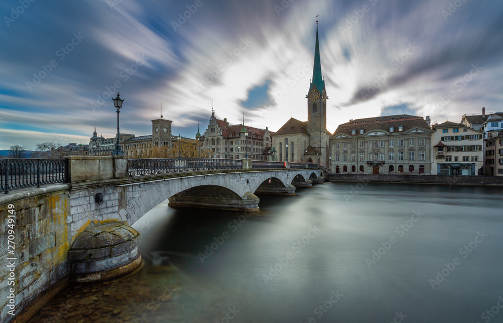 Kirche Fraumünster in Zürich, Switzerland. Panoramic Long exposure view of the historic city center of Zurich with famous Fraumunster Church from the river Limmat , Zurich, Switzerland. Kirche Fraumünster in Zürich, Switzerland. Panoramic Long exposure view of the historic city center of Zurich with famous Fraumunster Church from the river Limmat , Zurich, Switzerland.