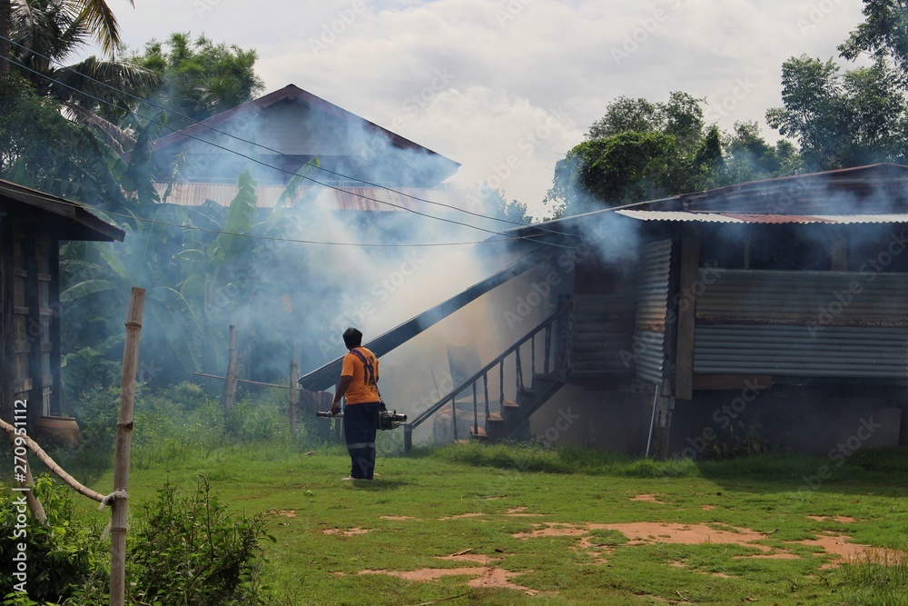 Employees are using fogging machines to get rid of mosquitoes to prevent dengue fever, take