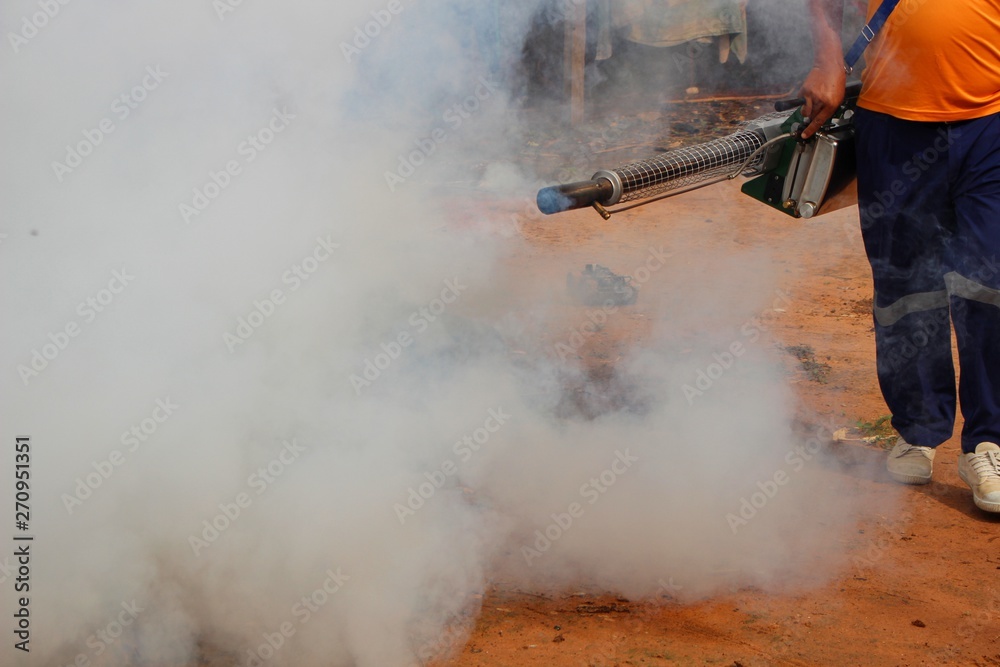 Employees are using fogging machines to get rid of mosquitoes to prevent dengue fever, take
