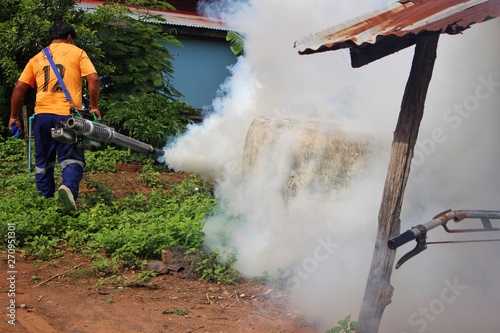Employees are using fogging machines to get rid of mosquitoes to prevent dengue fever, take blurred pictures