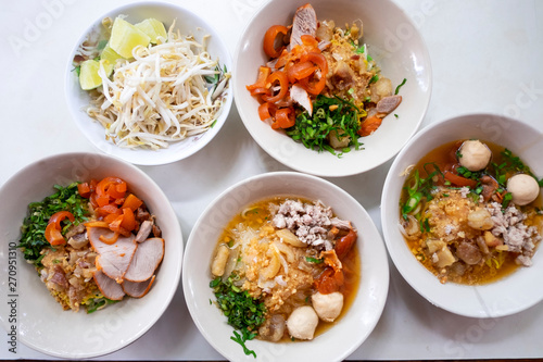 Top view thai noodle tom yum (Kuay Tiew Thai) with minced pork, red pork, pork ball.