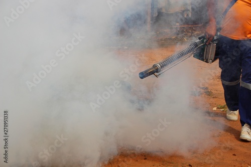 Employees are using fogging machines to get rid of mosquitoes to prevent dengue fever, take blurred pictures