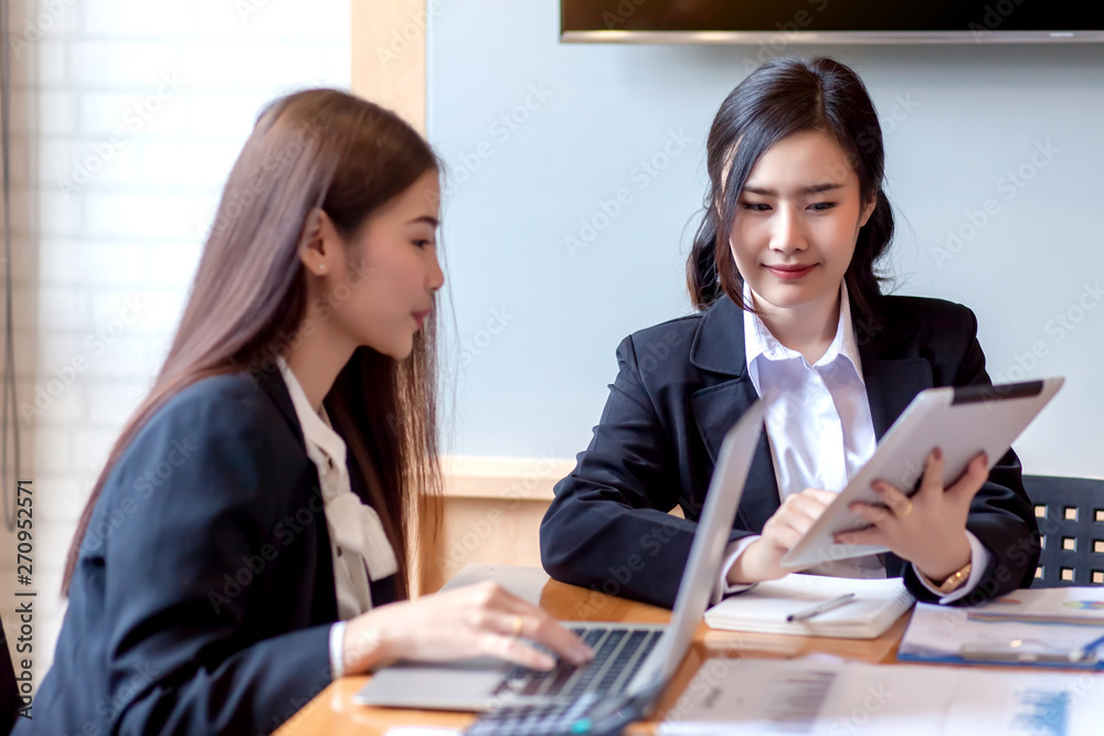 Two business woman Asian chat exchanging ideas at the meeting. Two business woman Asian chat exchanging ideas at the meeting.